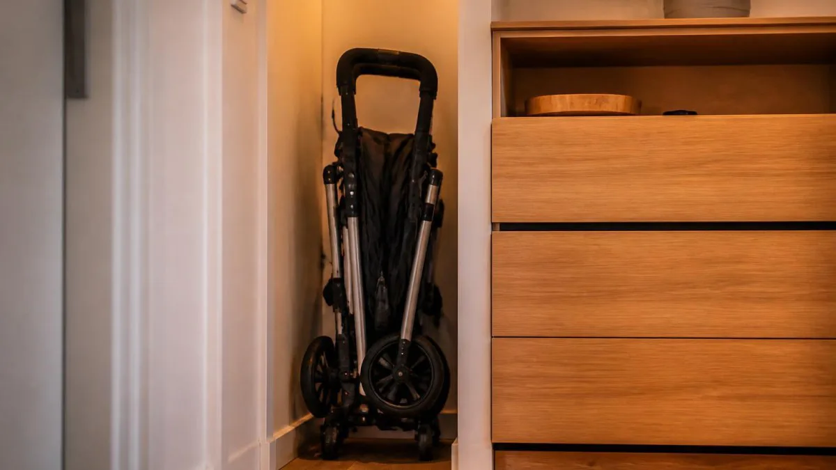 Gefalteter Rollator steht platzsparend senkrecht in einer Wohnungnische